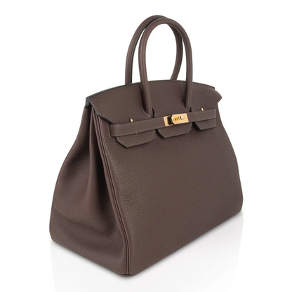 Rich Deep Chocolate Brown Soft Uniform Pebbled Grain Spacious Structured Hand Tote With Polished Golden Twist Lock Hardware And Coordinating Brown Suspended Metal Padlock Charm