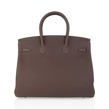 Rich Deep Chocolate Brown Soft Uniform Pebbled Grain Spacious Structured Hand Tote With Polished Golden Twist Lock Hardware And Coordinating Brown Suspended Metal Padlock Charm